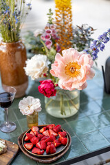 Delicious snack on garden table decorated with different flowers at backyard