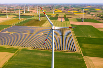 Generation of green energy in Germany by solar panels of a solar park and wind turbines up to the...