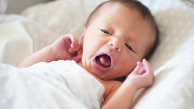baby newborn. little baby a newborn 1 month of life lies in bed in the maternity hospital. happy family kid dream concept. close-up baby lifestyle indoors. beautiful cute girl lies at home