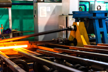 Machine for induction heating of metal. A metal rod heated in an induction furnace. Hot metal...