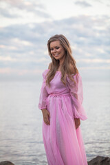 Happy beautiful woman, spring portrait on the beach. Young pretty female model outdoors