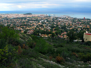 Fototapeta na wymiar Denia, view of the city from above from Mount Montgó. Roofs of houses, the sea in the distance, Spain