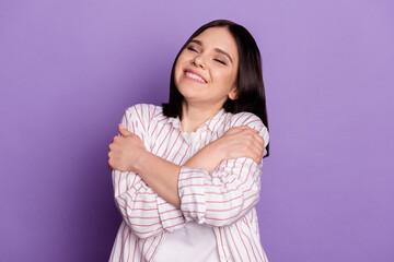 Fototapeta premium Photo of young cheerful lady good mood cuddle herself dreamy comfort isolated over violet color background