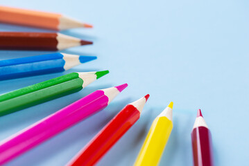 Colored pencils on a blue background. Back to school concept.