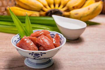 boiled bananas in syrup topped with coconut milk