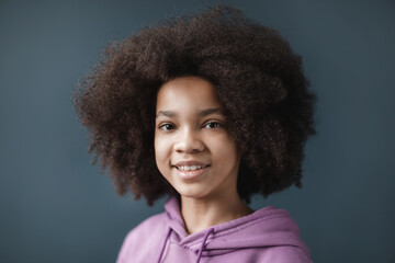 Portrait of positive african american girl smile, wears lilac hoodie