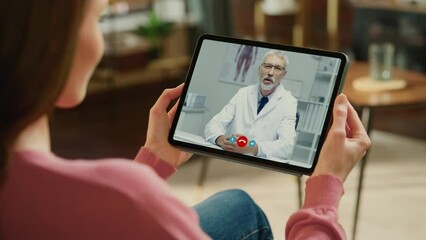 Young Girl Sick at Home Using Digital Tablet to Talk to a Doctor via Conference Video Call on Medical App. Beautiful Woman Checks Possible Symptoms with Professional Physician, Using Online Video Chat
