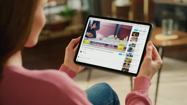 Over Shoulder: Woman using Tablet Computer to Watch Beauty Products Review. Presenters, Beauty Expert use Blush Palette on Model, Present the Best Cosmetics. Mockup Video Sharing Social Media Platform