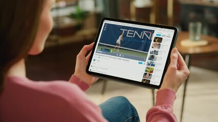 Over Shoulder Woman Using Tablet Computer Watching Female Tennis Championship Match. Professional Sports Athletes on Tournament. Live Streaming Video on Mock-up Video Sharing Social Media Platform - Powered by Adobe