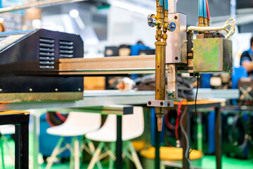 Close up nozzle head or torch of high precision cnc gas plasma cutting machine for manufacturing process cut perforated hole drilling etc of metal sheet plate pipe tube in industrial