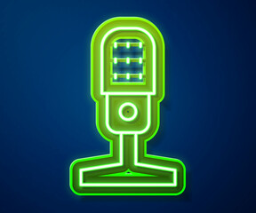 Glowing neon line Microphone icon isolated on blue background. On air radio mic microphone. Speaker sign. Vector