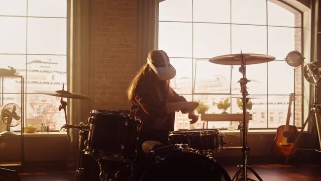 Portrait of a Young Female Wearing a Virtual Reality Headset, Playing Drums in at Home with Warm Sunlight. Drummer Girl Recording Herself Playing Music for Social Media Metaverse.