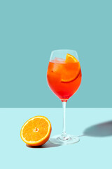 Spritz Veneziano cocktail with orange on blue background