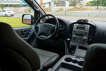 dashboard in dark colors in the interior of the minibus