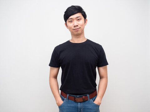 Confident man stand hand in pocket jean,Handsome asian man studio shot isolated