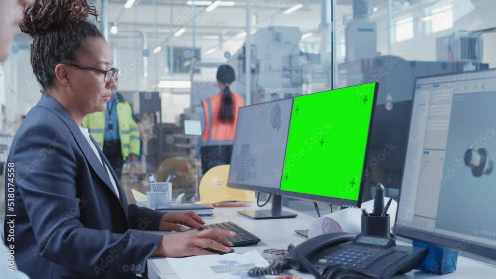 Leinwandbilder Factory Office Room: Industrial Engineers Developing Models of a Heavy Industry Machine Parts on a Computer 3D Software. One Computer Monitor Display is a Green Screen Mock Up Template.