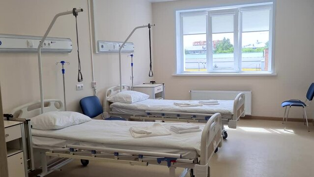 Two empty medical beds in the hospital ward. Modern medical ward with equipment