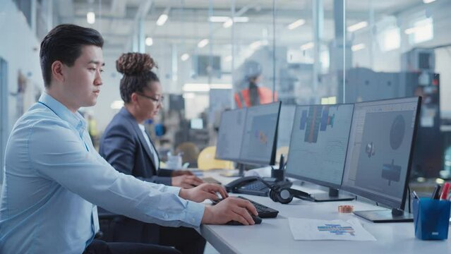 Factory Office Facility: Industrial Engineers Drafting Blueprints of a Heavy Industry Machine Parts on a Computer CAD Software. Modern Technological Industry 4.0 Research and Development Center.