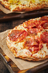 Two Roman-style pizzas with cheese and bacon. Roman square pizza or Pinsa on a thick dough, Italian Cuisine