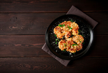 Steak, cauliflower , with cheese , spices, homemade, on a wooden table, dark background, close-up, top view, selective focus, no people,