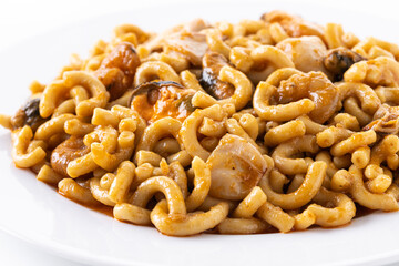 Traditional Spanish fideua. Noodle paella isolated on white background. Close up