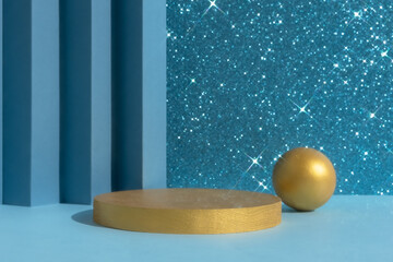 Golden podium on an abstract shiny sparkling blue background. A scene with a geometric backdrop. Showcase, display case for the presentation of a cosmetic product or gift.