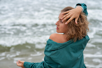 Portrait of a dancing woman near the sea - 518085585