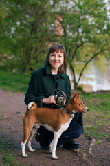 Woman with Basenji dog in nature - 518085586