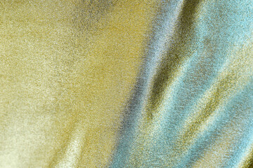 Fototapeta na wymiar Golden fabric or cloth as background with luxury concept. copy space