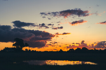 sunset over the lake with natures silhouette