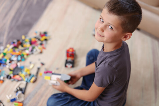 top view of a boy playing blocks and looking at the camera. High quality photo
