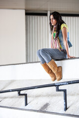 Urban Fashion. A beautiful young mixed race girl on location waiting patiently. From a series of...