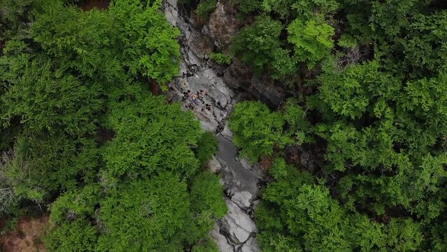 view from the sky of a group of unrecognizable people get ready to go canyoning. The gorges of the Ardeche in France seen from the sky. Canyon of the river "Ardeche", in the south of France