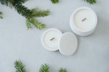 Group of Handmade Candles on Light Background Among Fir Branches. Christmas Concept