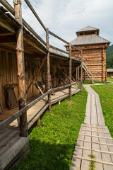 Fototapeta na wymiar Elekmonar, Fort Kuyum, Chemal district, Altai Republic, southern Siberia, Russia - July, 2020: Full-scale reconstruction of the Siberian Cossack Ostrog 18th century among the Altai mountains