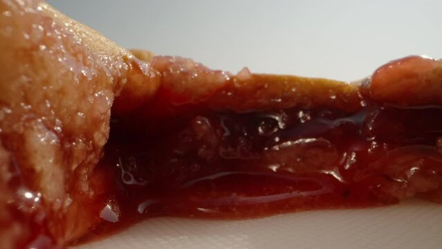 pie with cherry jam, cut on the table, the jam flows down on the table. Dolly slider extreme close-up. Laowa Probe
