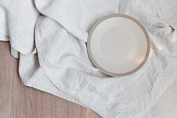 Modern ceramic tableware on table with copy space. Trendy plates, cutlery and linen napkins...