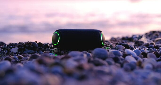 A Portable Speaker At Sunset On The Beach