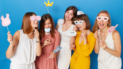 A front image of a group of happy friends to have gender reveals envent, isolated blue background.