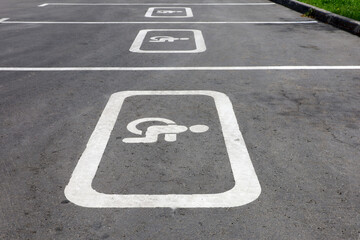 Fototapeta premium Disabled parking road signs on the street. Handicapped parking spot, sign of wheelchair painted on asphalt