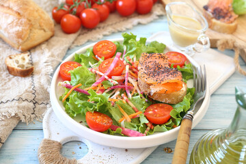 Healthy food. Lettuce salad with red fish, raw vegetables and olive oil. Red fish sandwich with rye bread, poppy seeds and mustard sauce