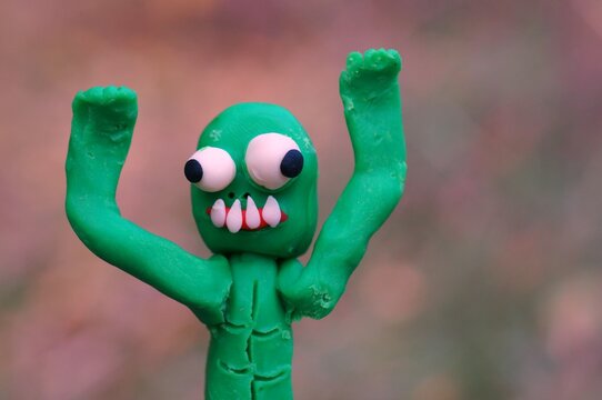 Portrait of a funny zombie made of plasticine close-up. A harmless monster.