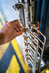 asian worker opens a latch.