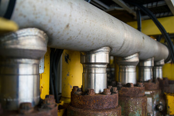 A steel pipe with another pipe connected by several large welded pipes.