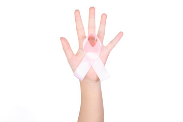 International symbol of Breast Cancer Awareness Month in October. Close up of female hand holding satin pink ribbon awareness isolated on white background. Women's health care and medical concept.
