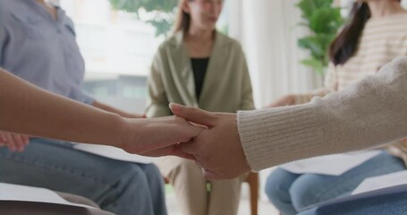 Closeup asia Gen Z people hold hand join health care social issue class rehab center club. Young woman team sit circle smile trust talk share on stress relief session workshop at work office seminar.