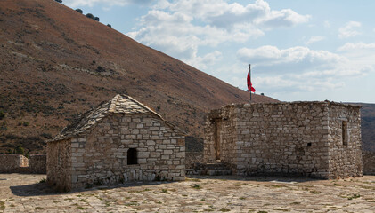 Porto Palermo, Albania - September 2021: Old fortress in Porto Palermo in Albania and Albanian flag