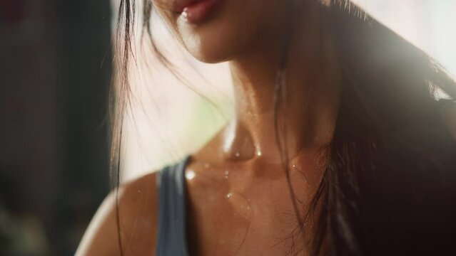Strong Asian Female Wipes Sweat Looks at Camera. Successful Empowered Woman Fighting and Winning fight Against Injustices, Prejudices. Cinematic Stylish Sensual Face Revealing Elevating Portrait