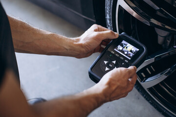 Repairman checking pressure sensors with a special tool