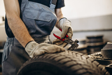 Repairman at car service changing tires